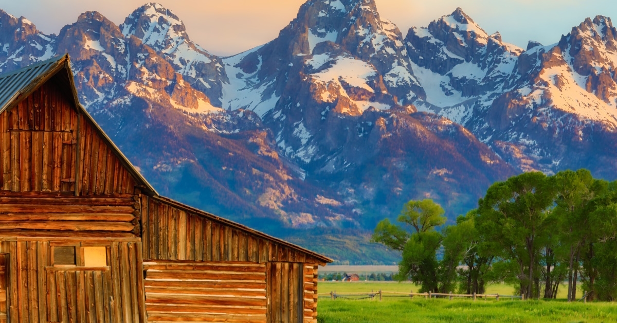 An abandoned, vintage barn in Mormon row with Grand Tetons in the background located in Jackson Hole, Wyoming