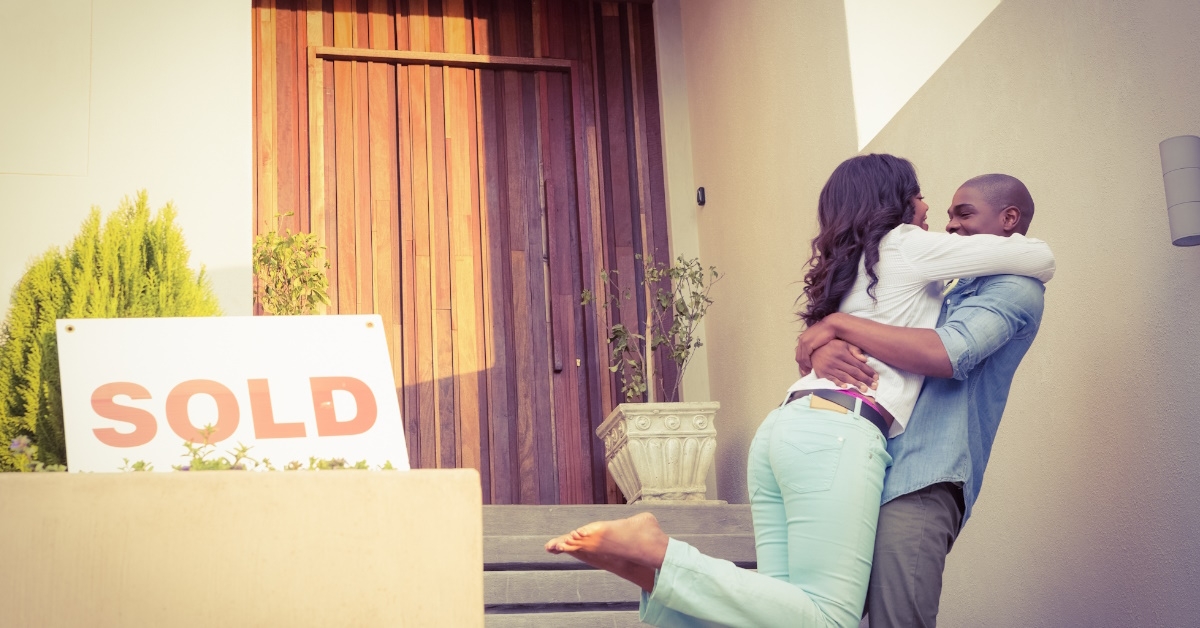 happy african american couple celebrating next to a 
