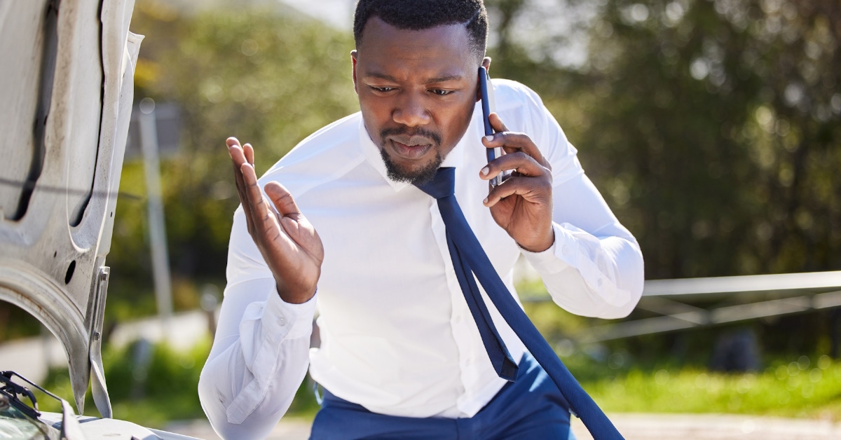 Frustrated black man is calling his auto-mechanic after his vehical breakdown for motor.