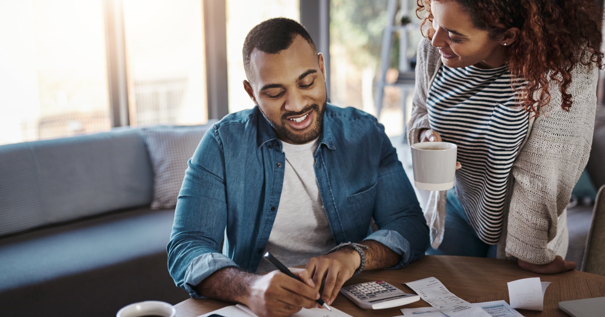 couple with list in notebook budget and finance
