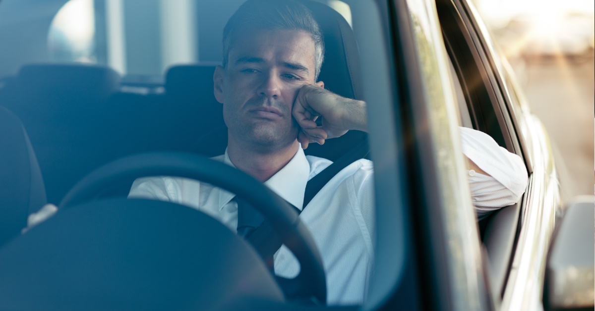 Handsome young man with his hand on cheeks is worried about his car