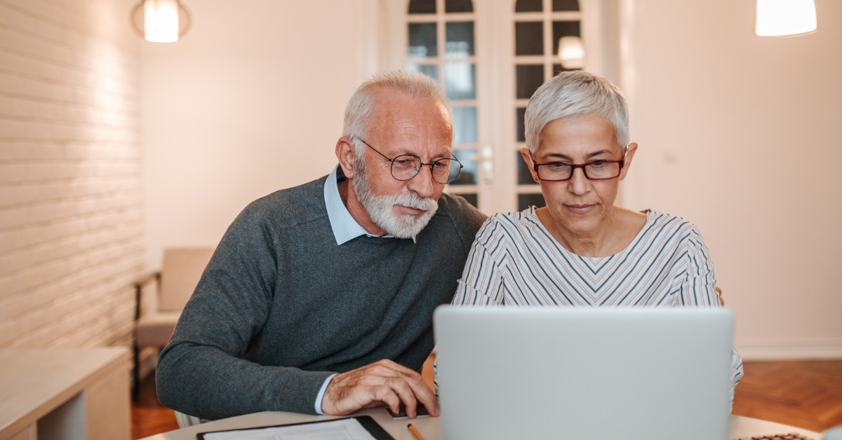 senior couple adding more amount in the budget they previously made due to increasing inflation rate.