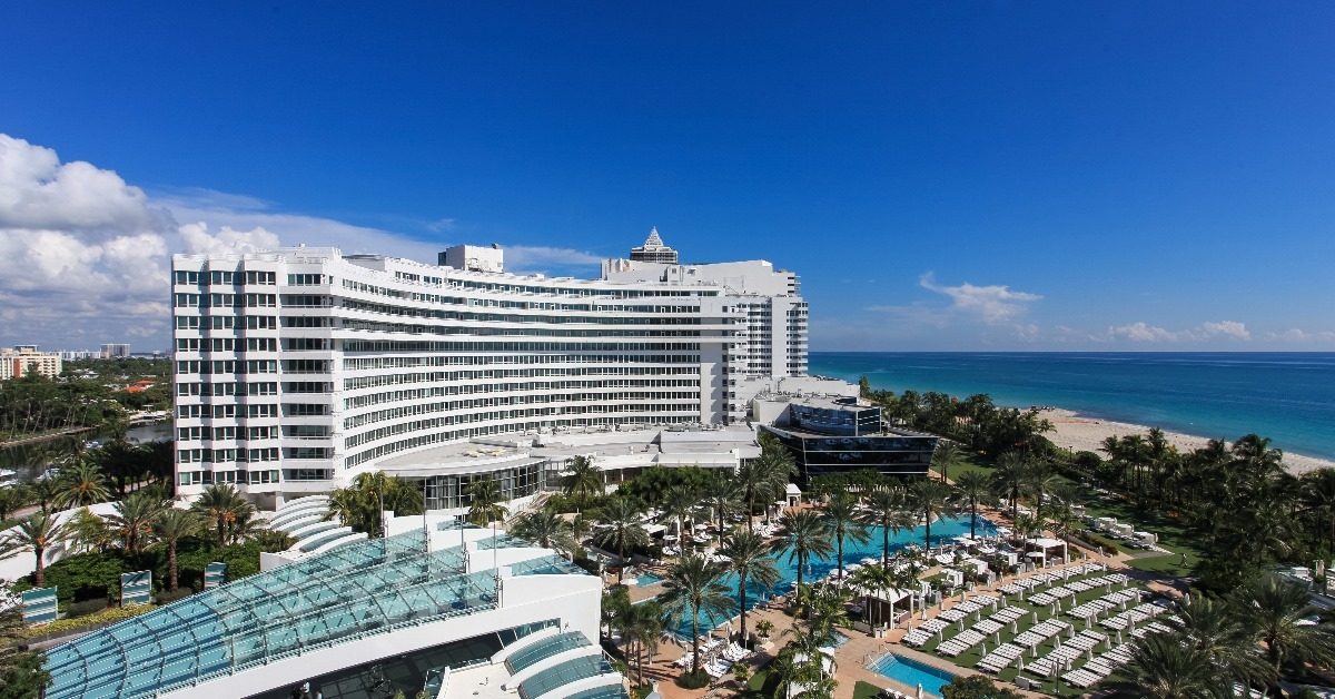 fontainebleau hotel with plenty of pools surrounding palm trees on miami beach