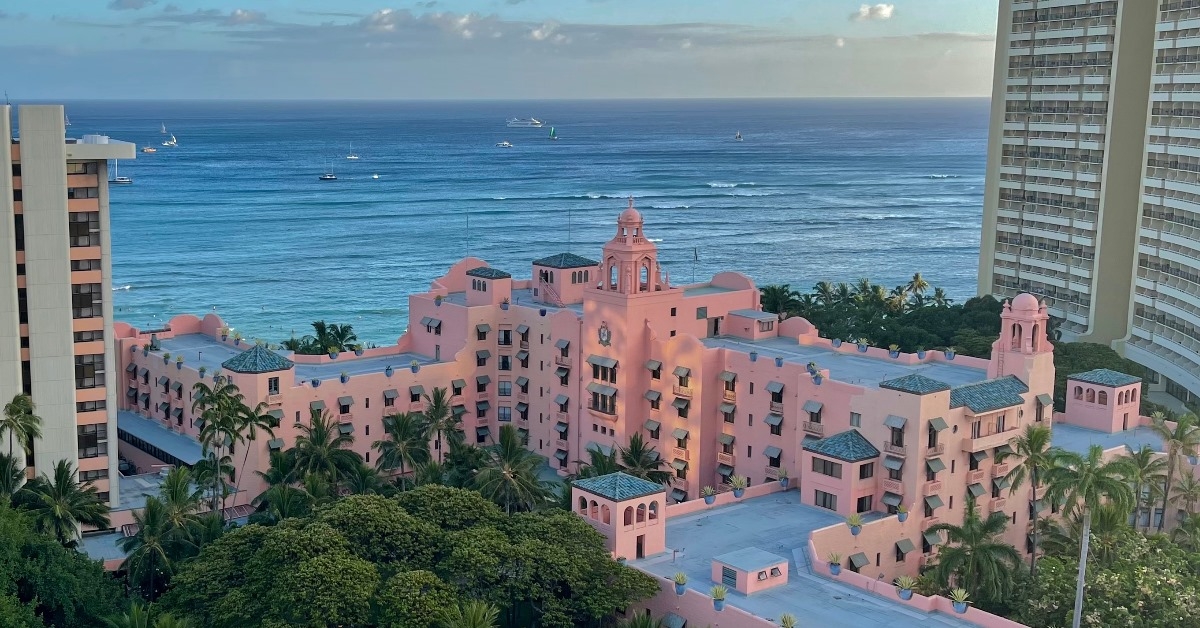 royal hawaiian hotel located on waikiki beach with crystal blue water and lush greenery in honolulu hawaii