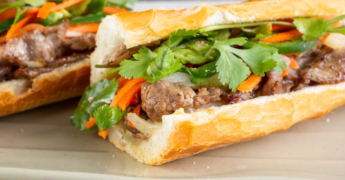  The teriyaki beef banh mi, a Vietnamese sandwich, complete with parsley leaves and a variety of vegetables, at a restaurant.