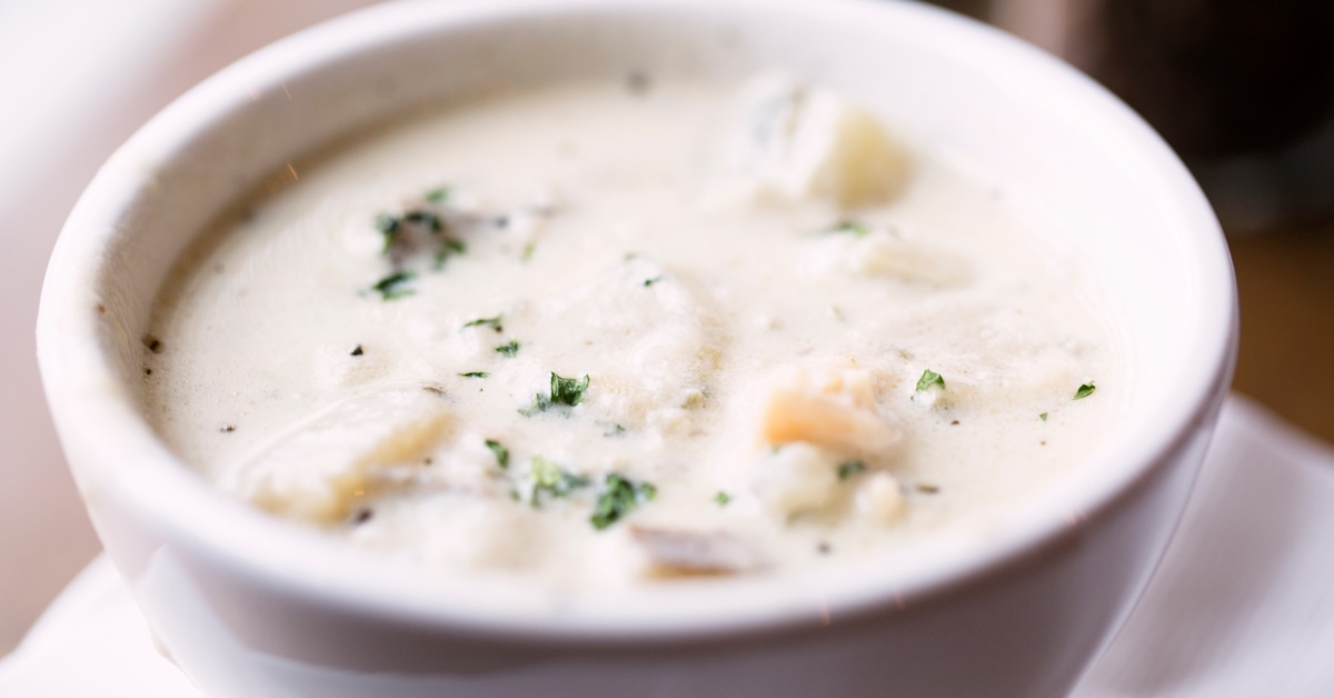 Bowl of new England clam chowder,made with thick creamy milk, clams, potatoes, and onions;