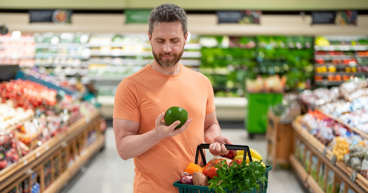 man with fruits and vegetables at grocery store
