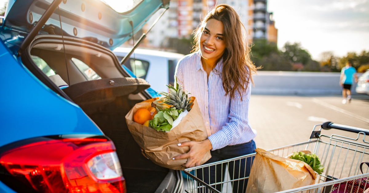 woman walking to the car after shopping at the supermarket