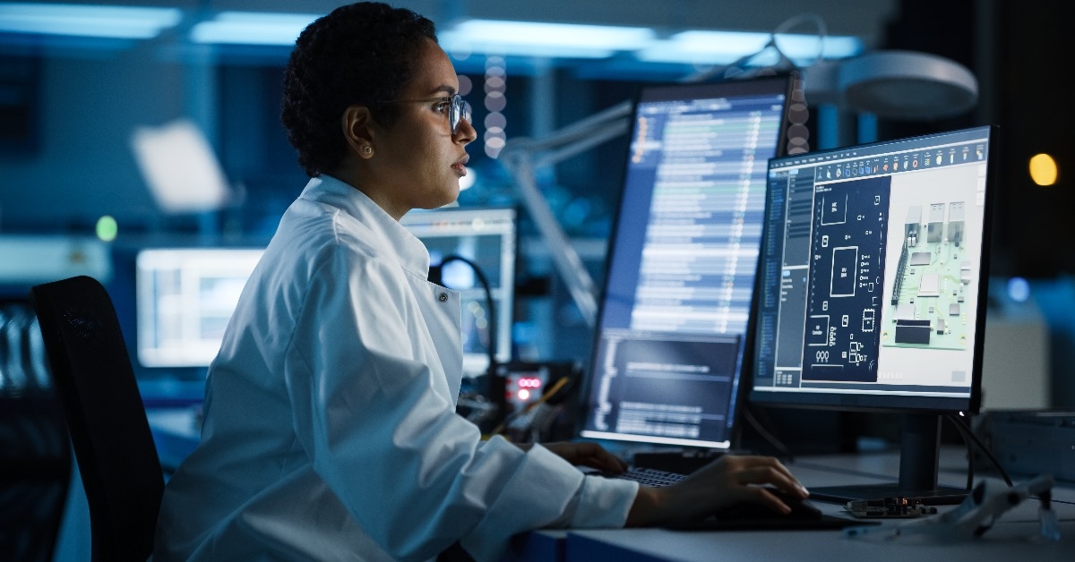 An engineer is using computer-aided design software on a computer, which can help in the development of industrial PCB, silicon microchips, semiconductors, and telecommunications equipment.