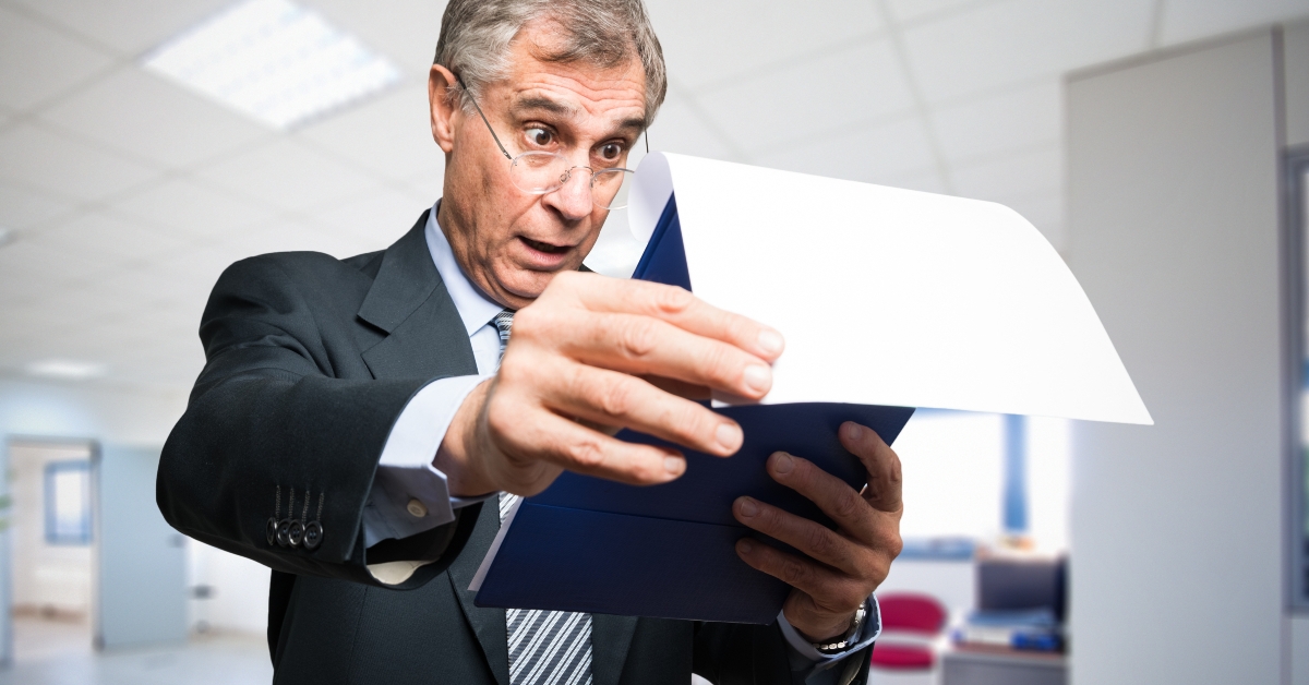 surprised businessman reading a document