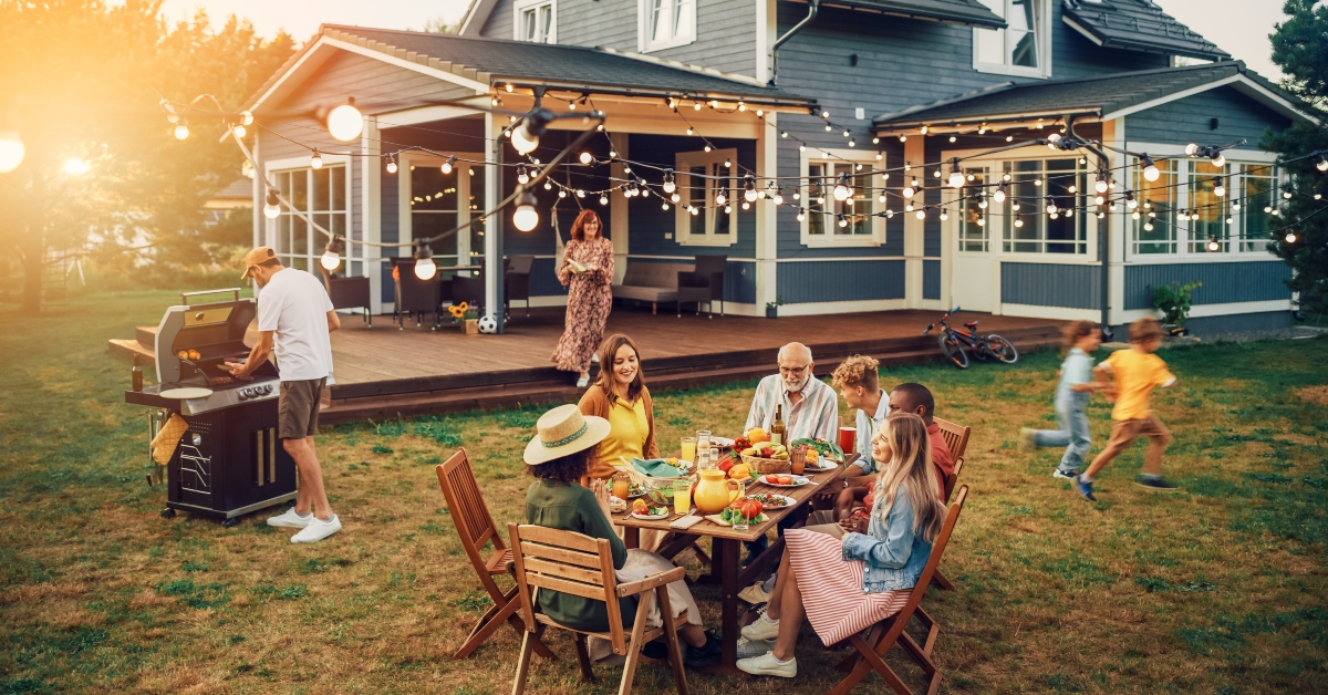 big family and friends celebrating outside at home