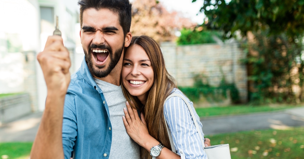 A couple holding a key