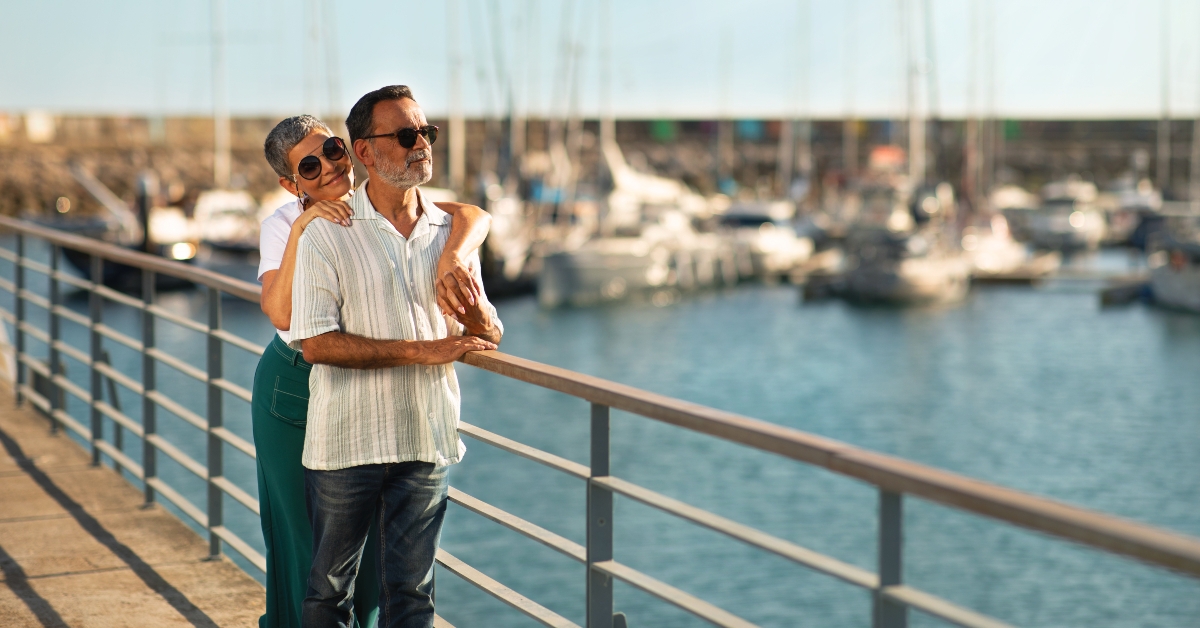 senior couple hugging at marina pier