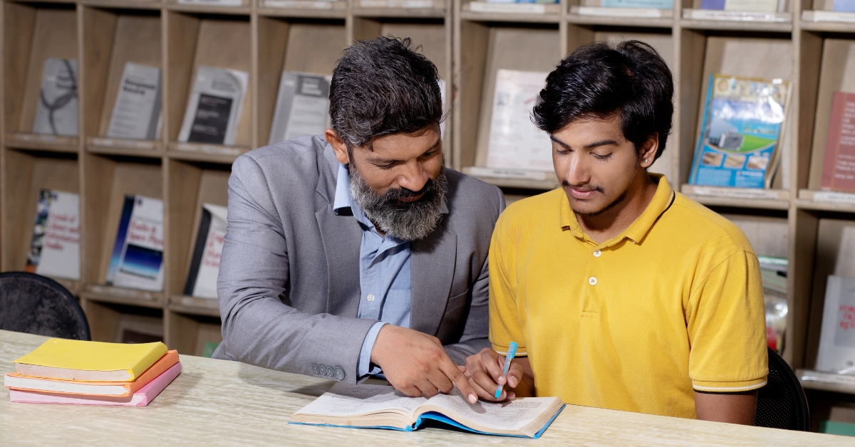 teacher reading book studying in college library