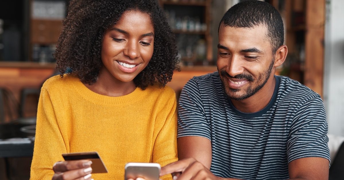 young couple shopping online through mobile phone