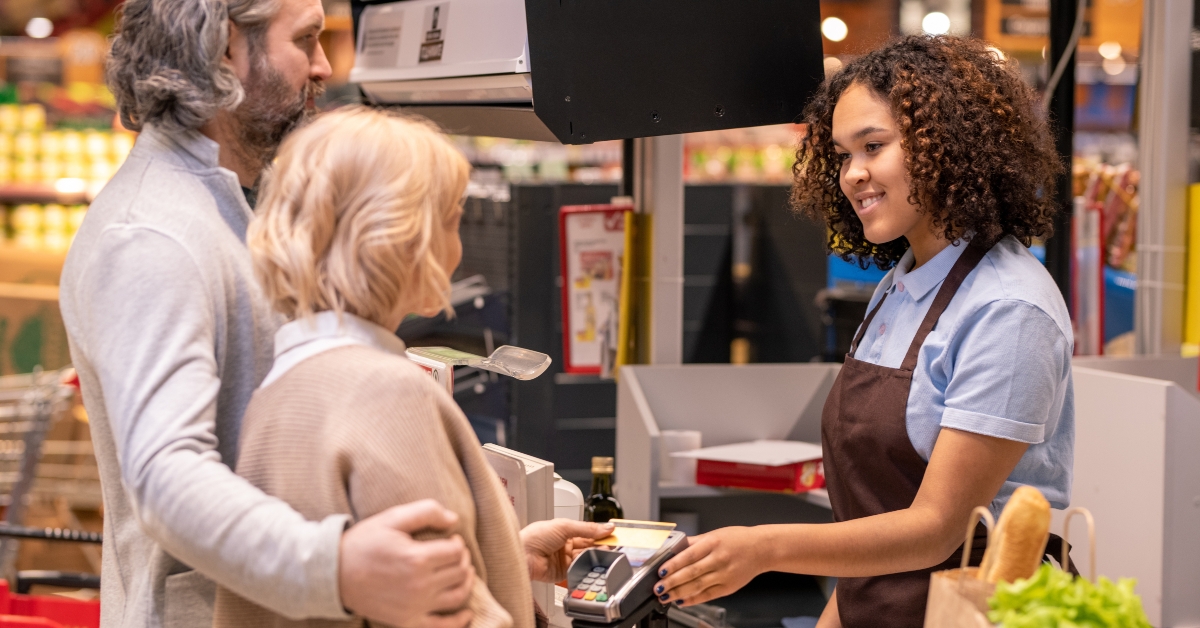 young mixed-race female cashier in apron