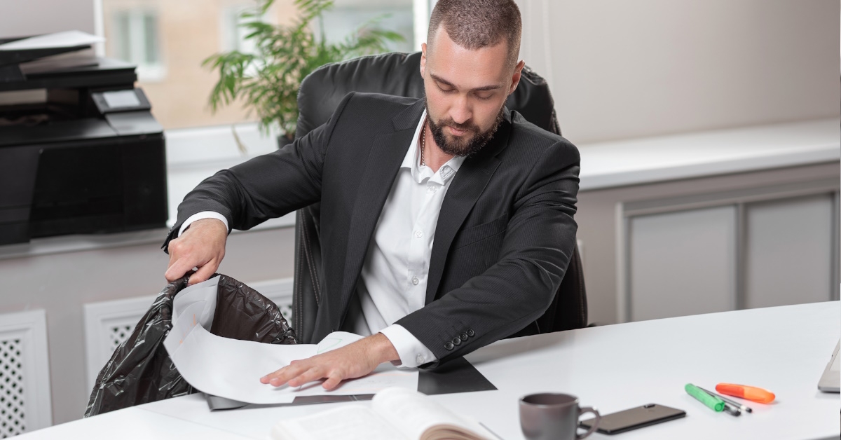 businessman at office throwing garbage