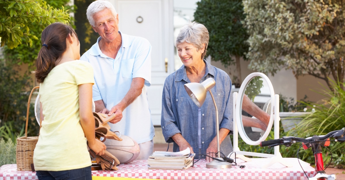 senior couple holding yard sale outdoor