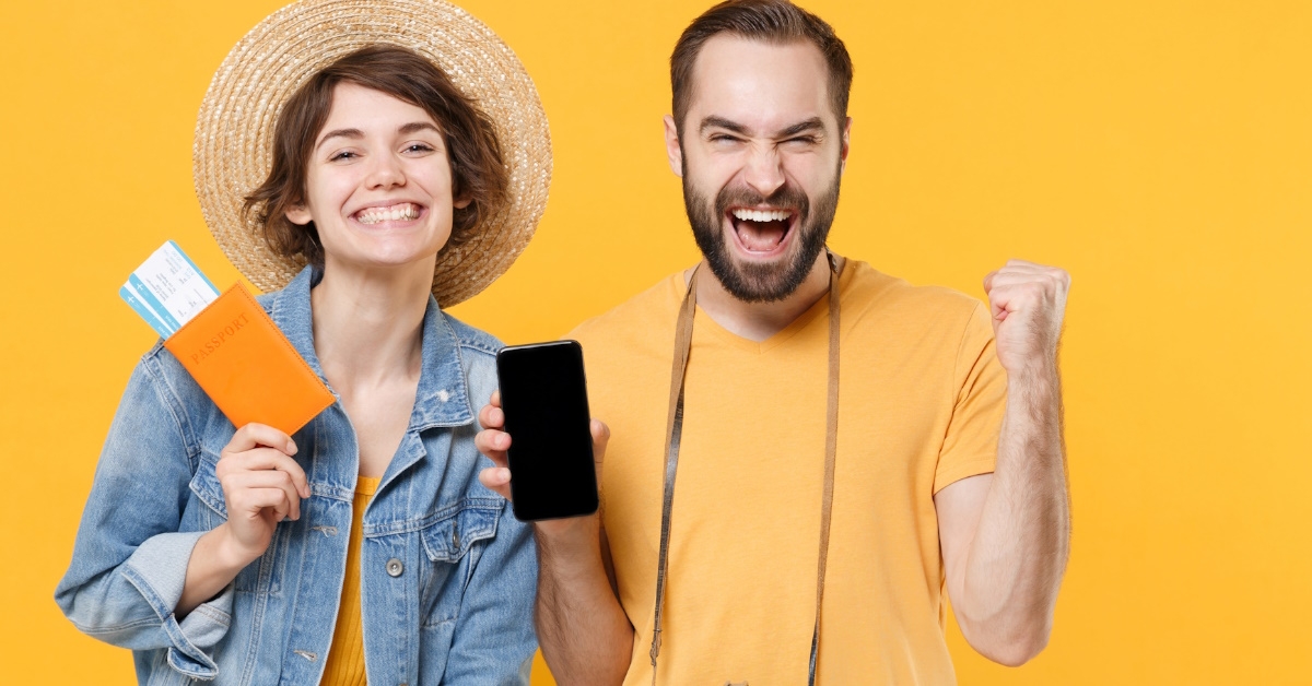 happy tourist couple waving passport