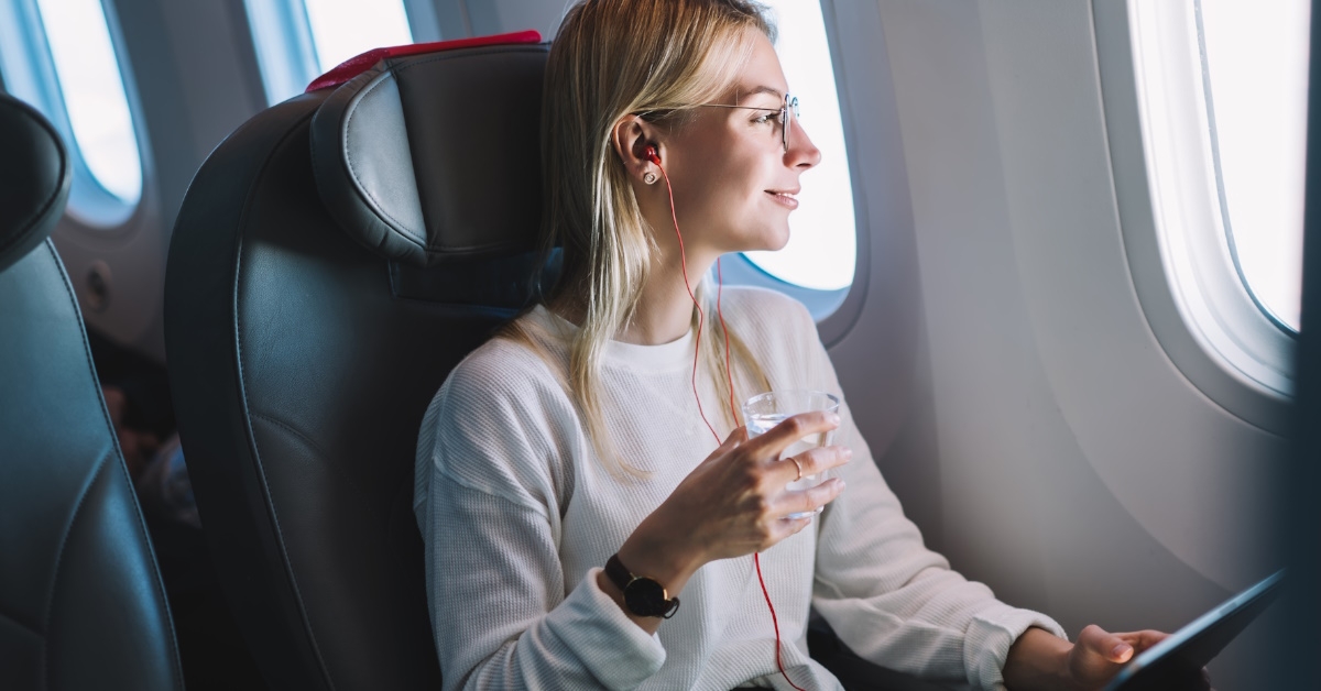 woman on airplane using laptop