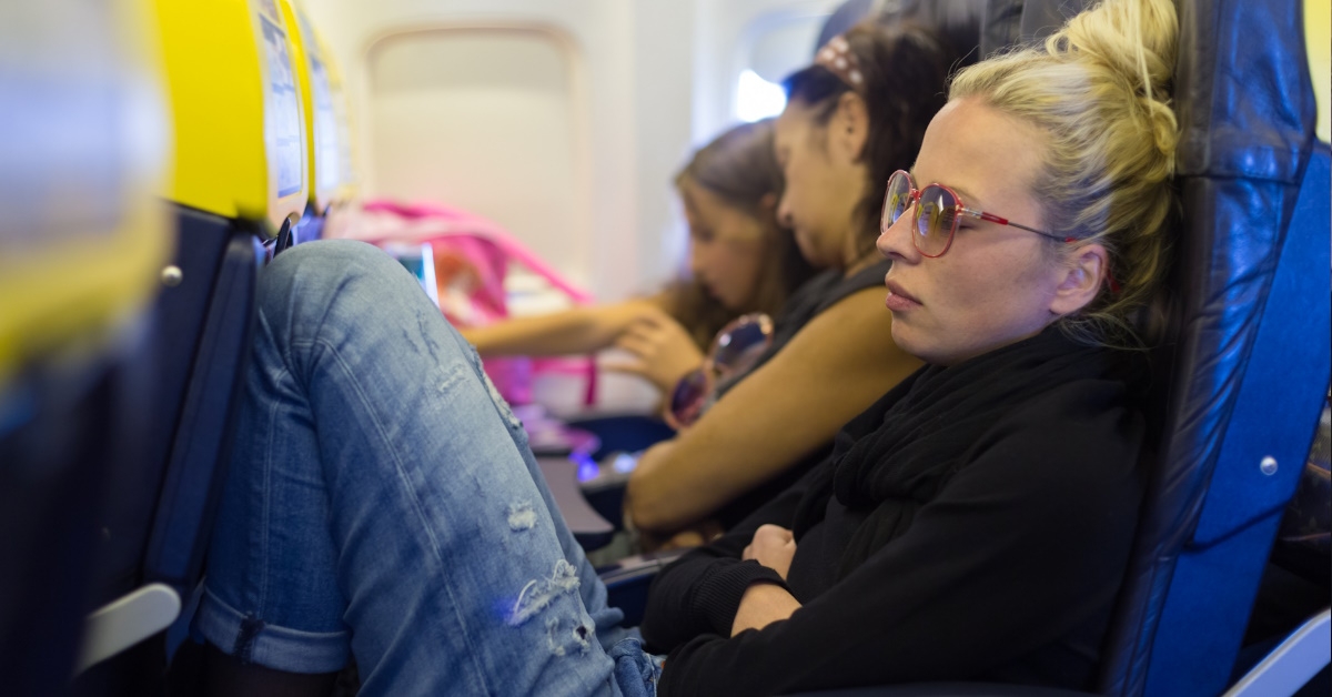 woman napping in airplane seat 