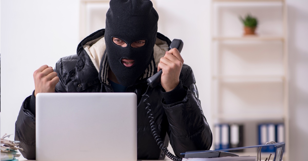 male burglar on phone at office