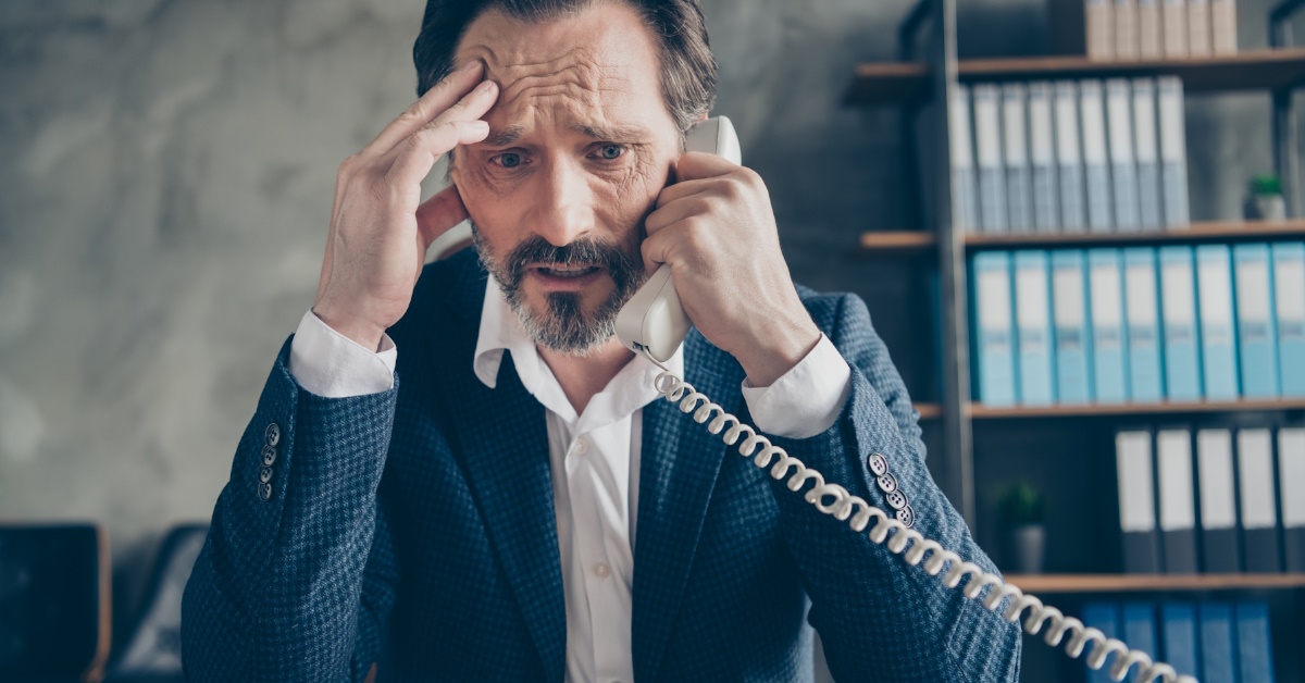 depressed businessman talking on phone