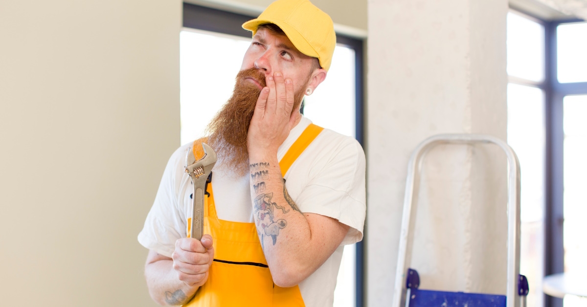 bored handyman holding wrench for renovation