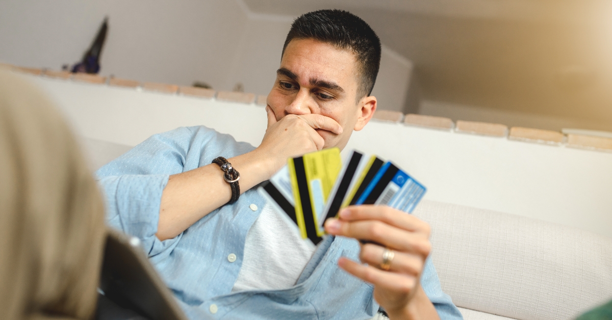 man holding credit cards