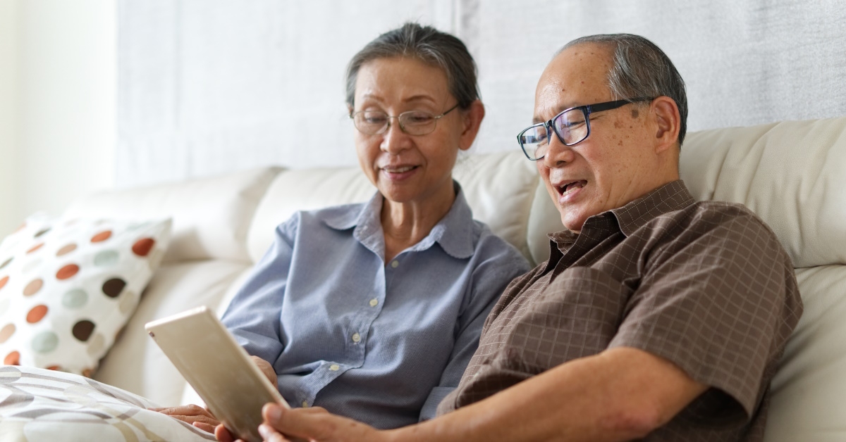 happy senior couple using tablet together