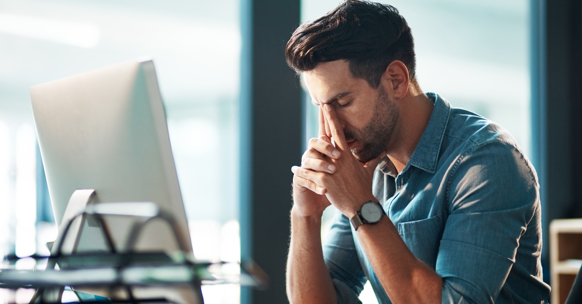 tired worker in front of computer