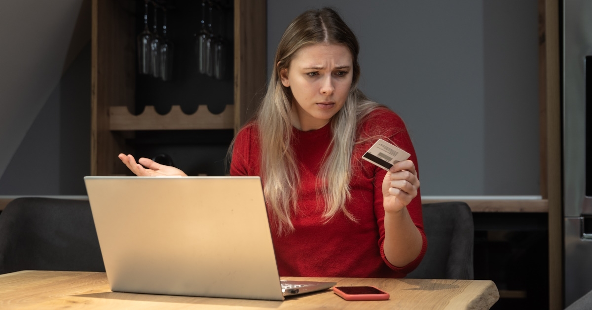 woman angry at card in hand