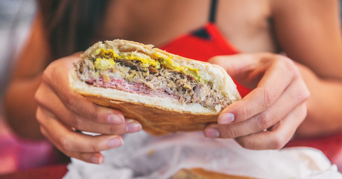 woman holding cuban sandwich