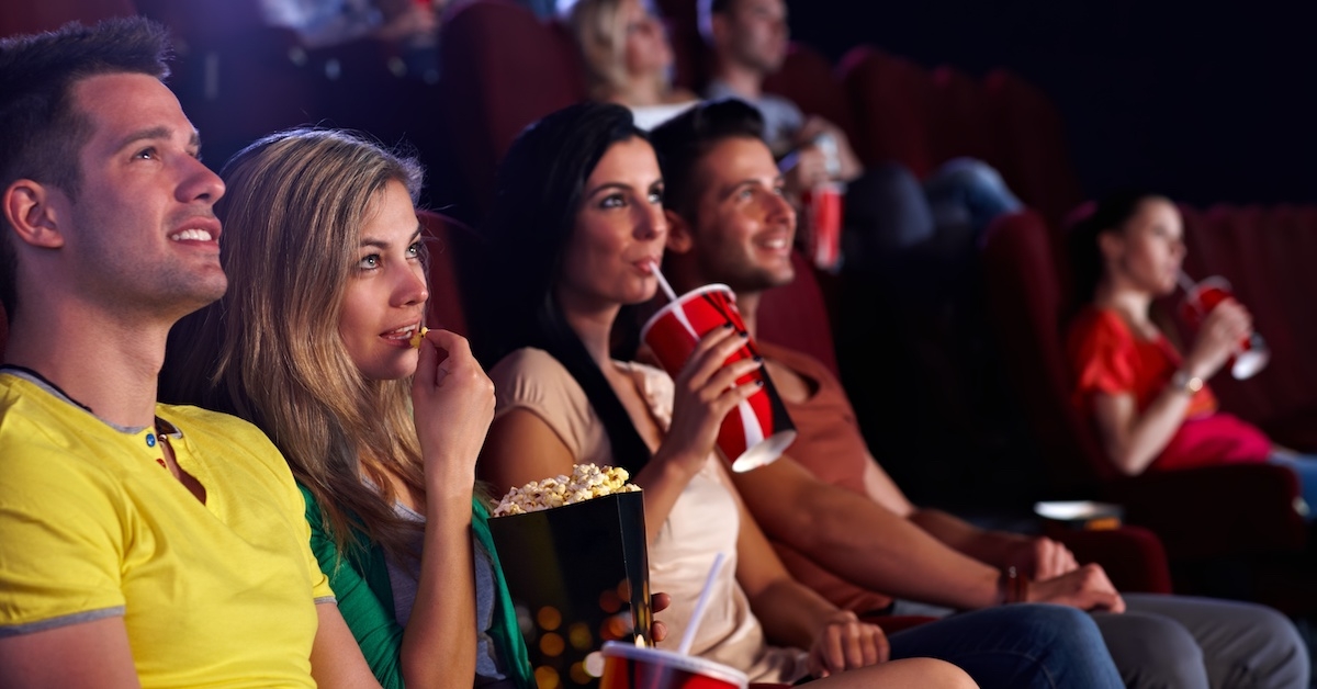 Multiple people watching a movie in a theater