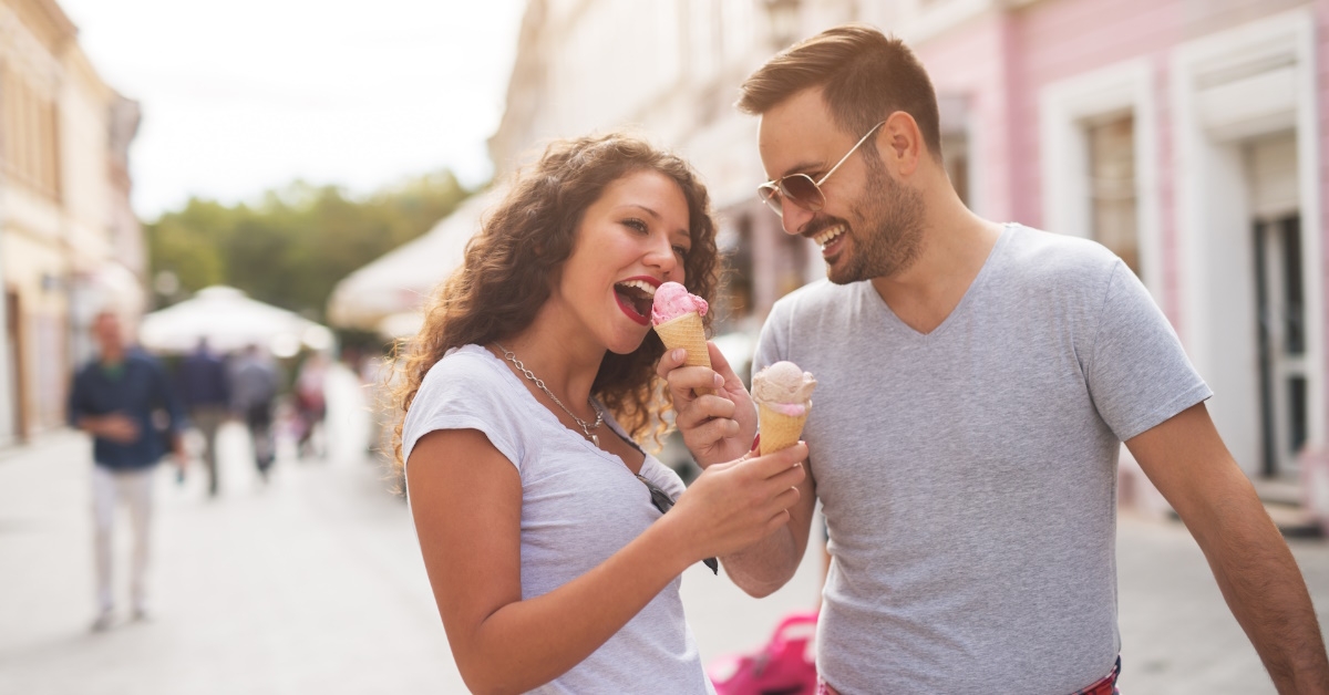 man sharing ice cream with wife