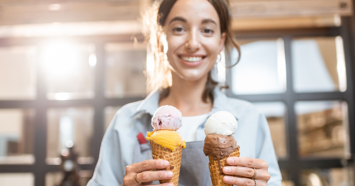 seller holding two yummy ice creams.