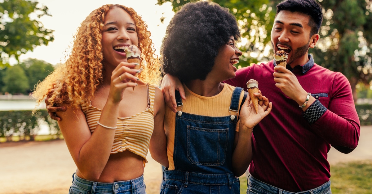 three friends having fun eating ice cream