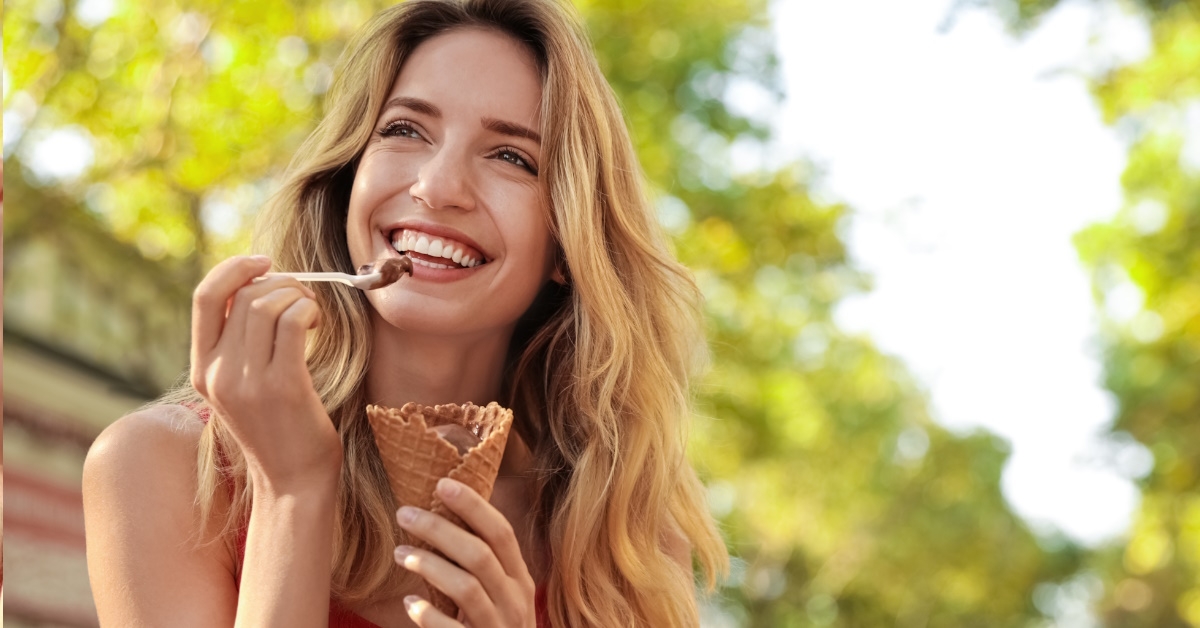 woman eating chocolate ice cream in waffle cone