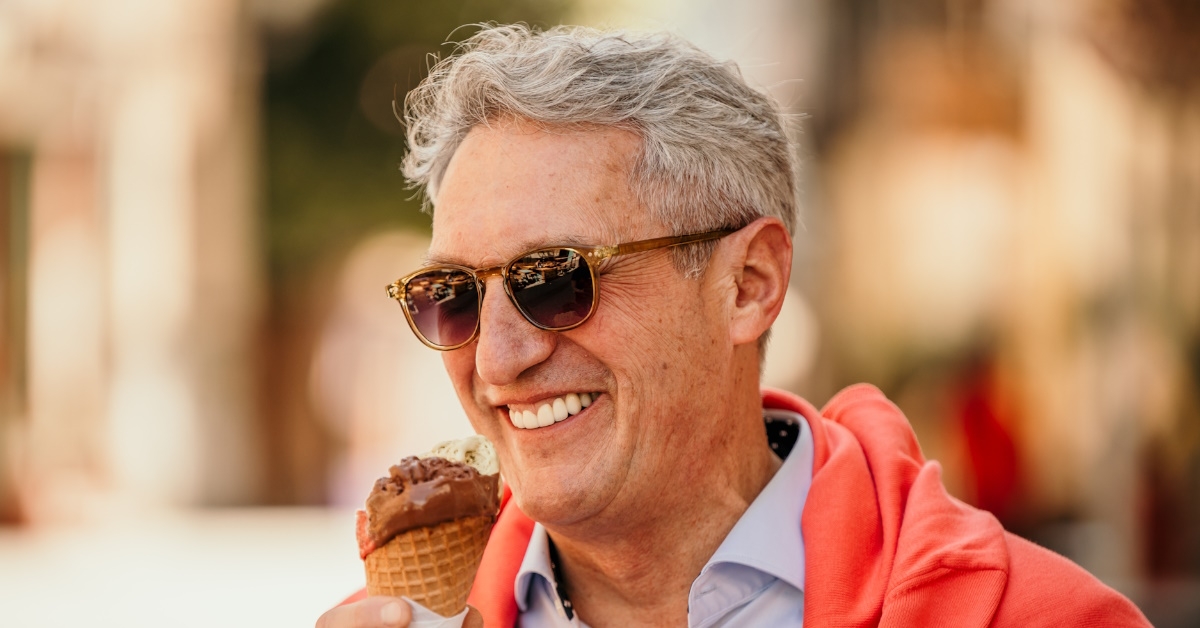 elegantly dressed man eating ice cream