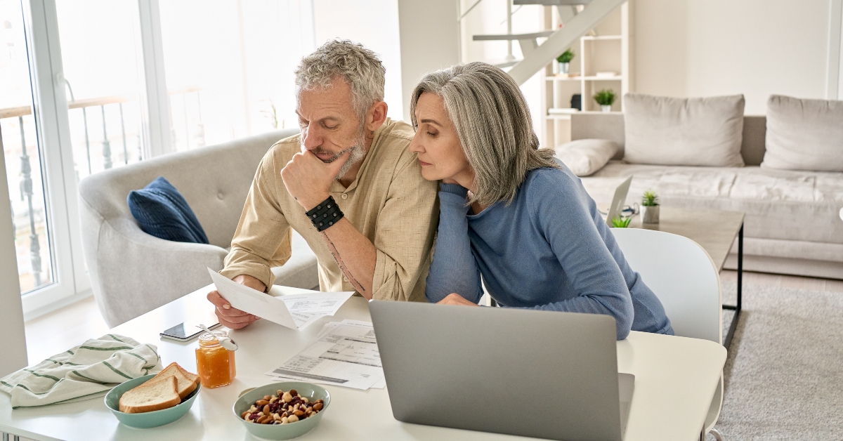 senior couple checking bank documents