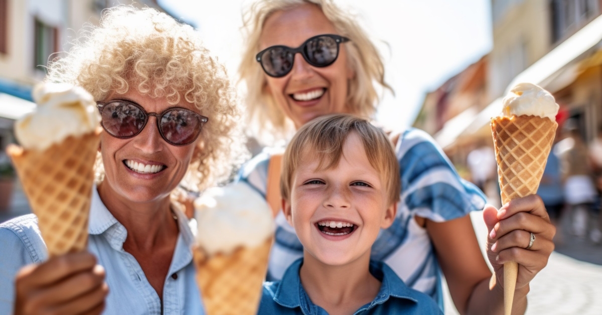 two ladies and a boy enjoying ice creams.