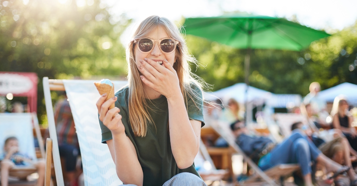 woman laughing and eating ice cream