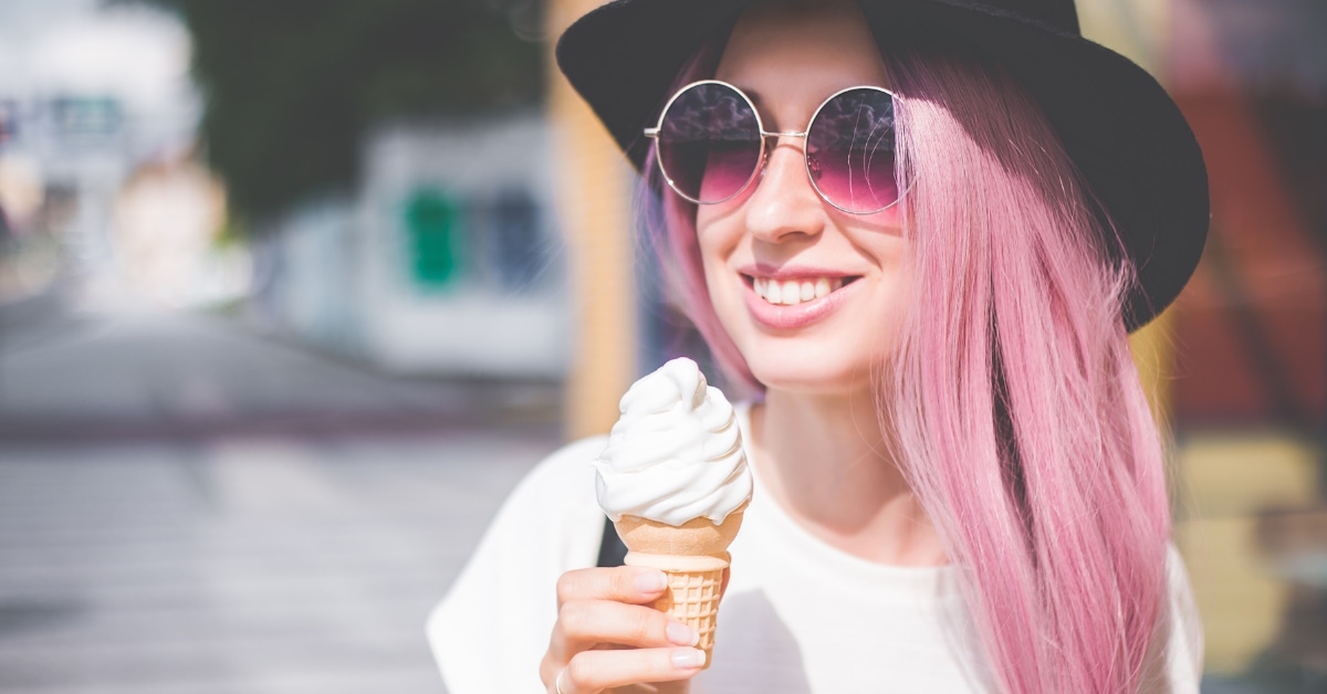 hipster woman eating ice cream outdoors.