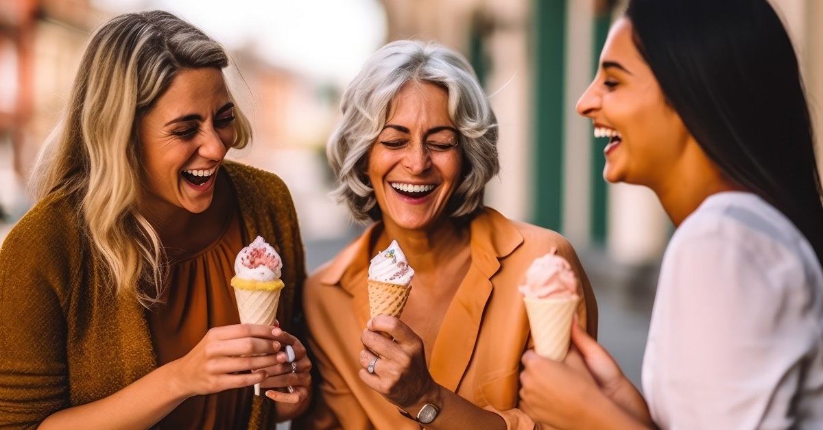 women enjoying ice cream outdoors.