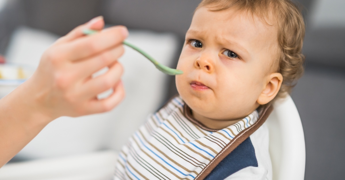 angry baby boy eating food