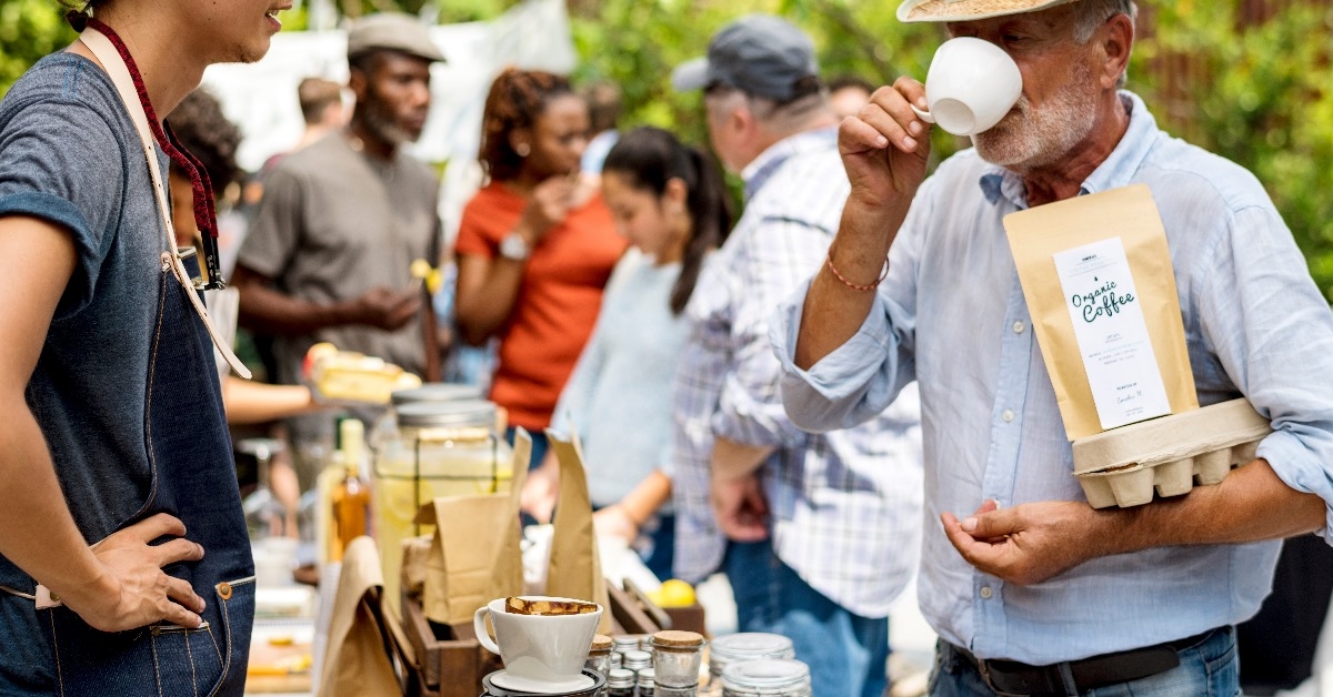 gentleman enjoying a cup of tea at food festival.
