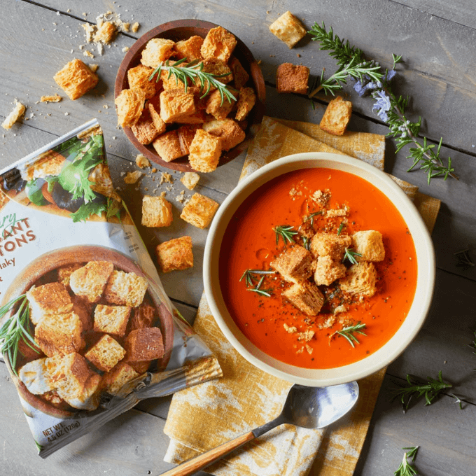 A bowl of soup with croutons