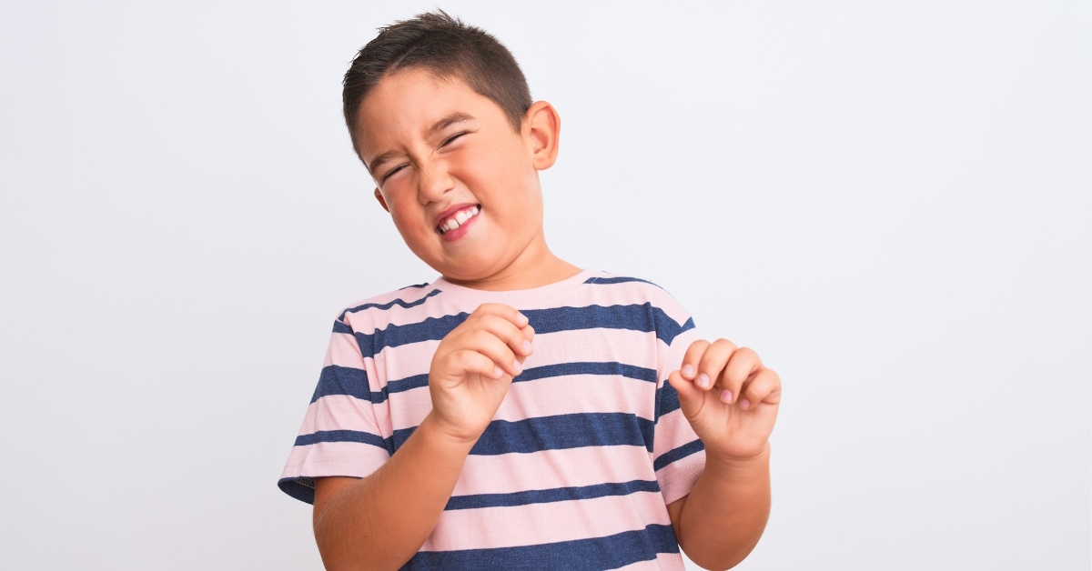 boy throwing tantrums over white wall