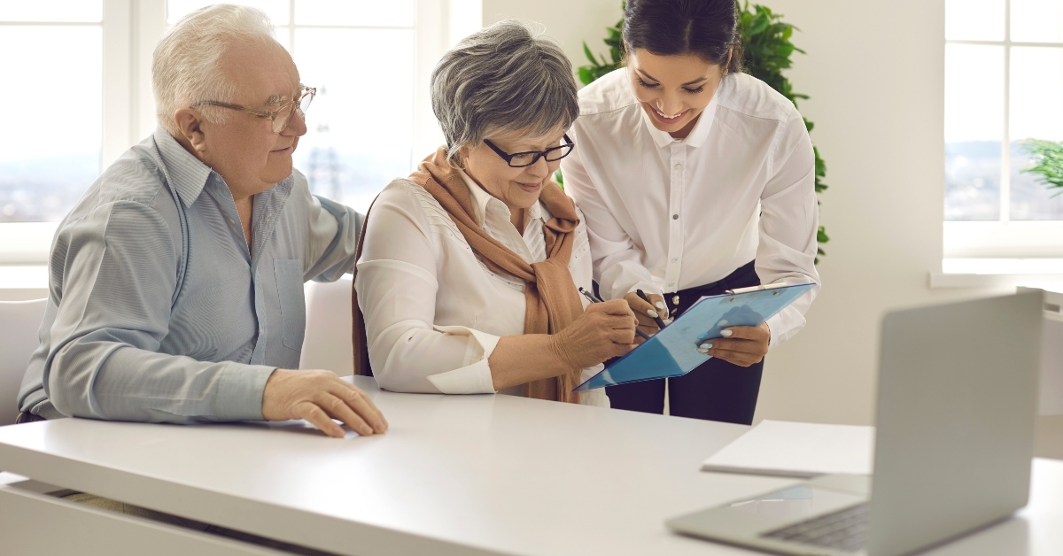 Older couple signing paperwork