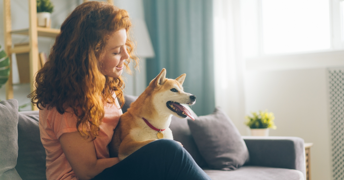 redhead woman is hugging dog